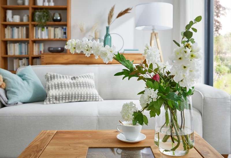 Home decor ideas with flowering plants including roses, jasmine, marigolds, sunflowers, and petunias adding beauty and freshness to indoor spaces.